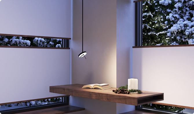 Dim interior with a wooden shelf, candle and pendant light, a window looking onto a snowy landscape at dusk